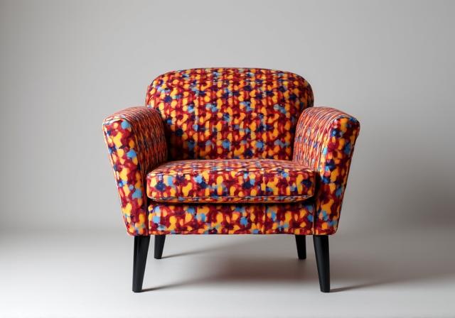 A modern chair with bold, patterned custom upholstery.